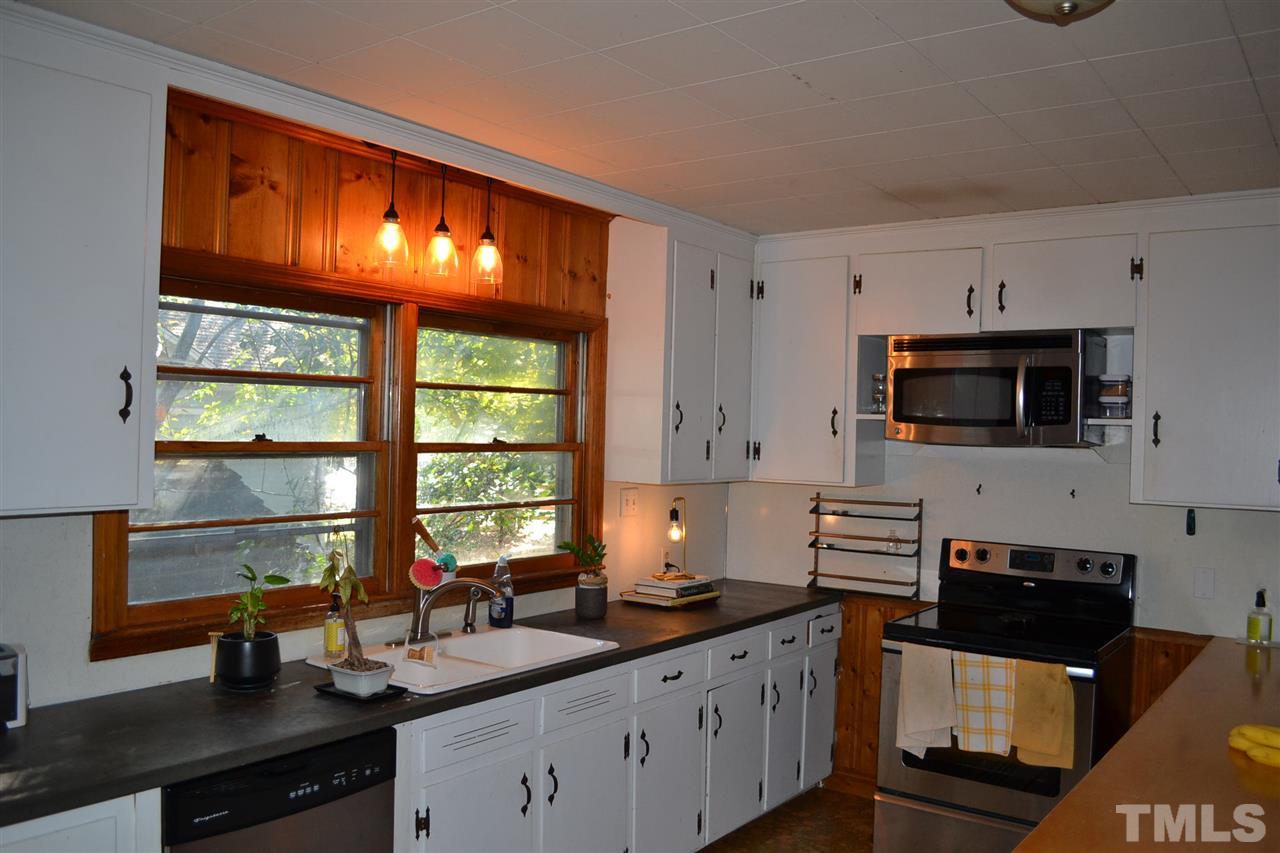 1604 Carson Street Raleigh, NC 27608 - Photo 8 of 28 a kitchen with stainless steel appliances a sink stove and microwave