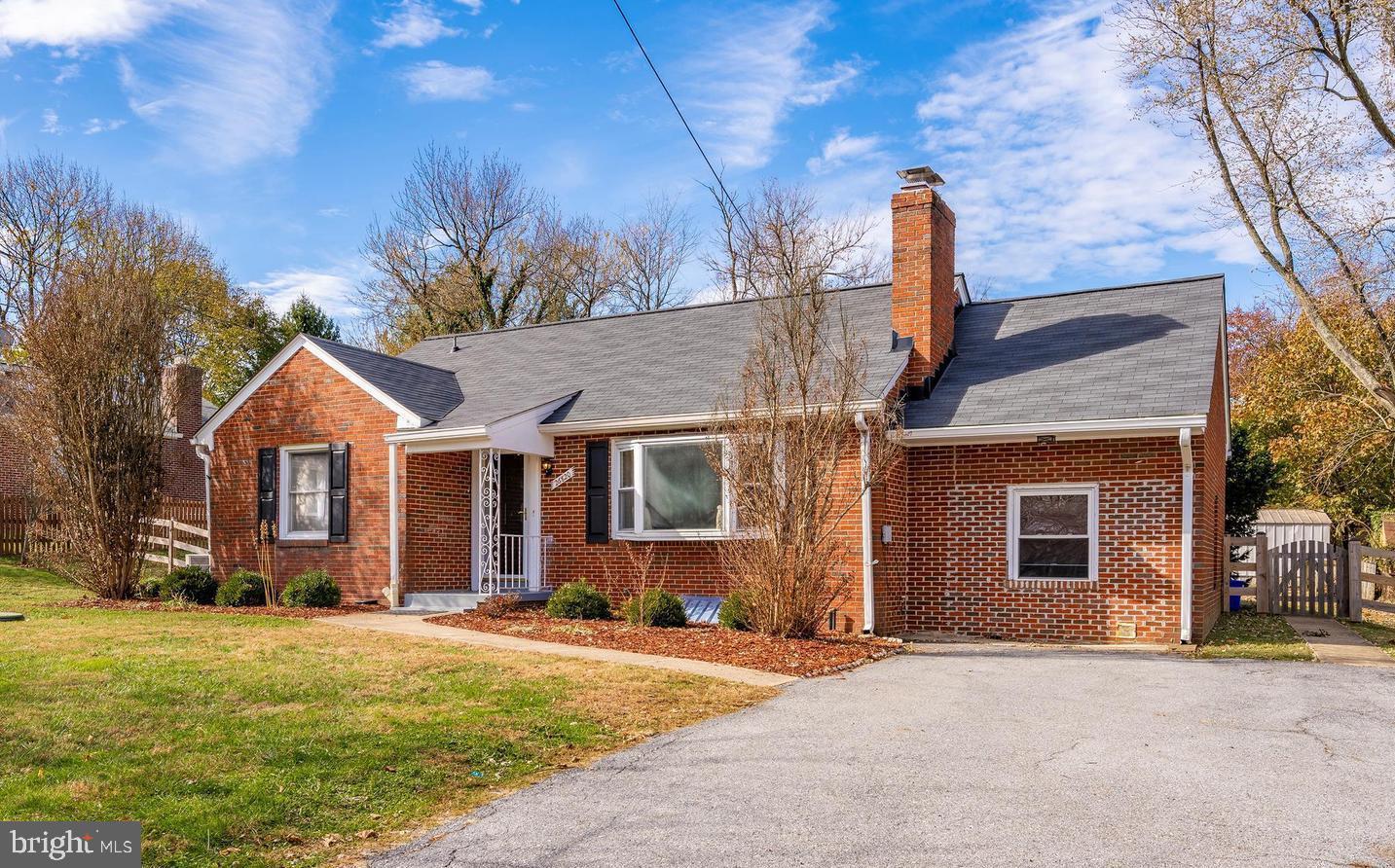 26820 Ridge Road Damascus, MD 20872 - Photo 1 of 25 a front view of a house with a yard and garage