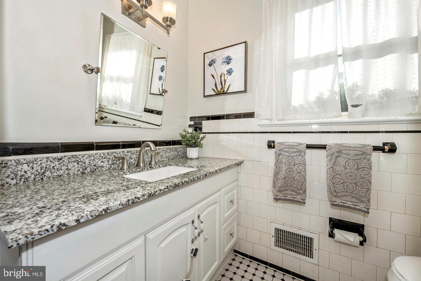 26820 Ridge Road Damascus, MD 20872 - Photo 22 of 25 a bathroom with a granite countertop sink and a mirror