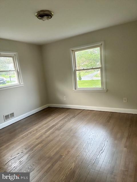 26820 Ridge Road Damascus, MD 20872 - Photo 7 of 25 an empty room with wooden floor and windows