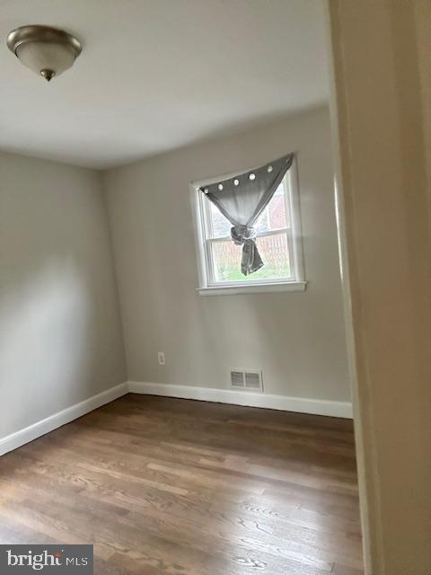 26820 Ridge Road Damascus, MD 20872 - Photo 8 of 25 an empty room with wooden floor and windows