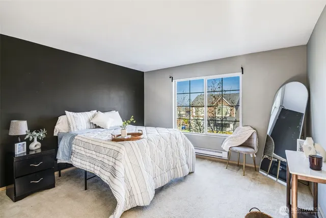 a bedroom with a bed and a large window