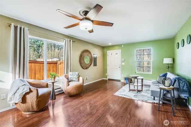 a living room with furniture and a wooden floor