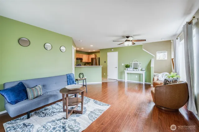 a living room with furniture and a wooden floor