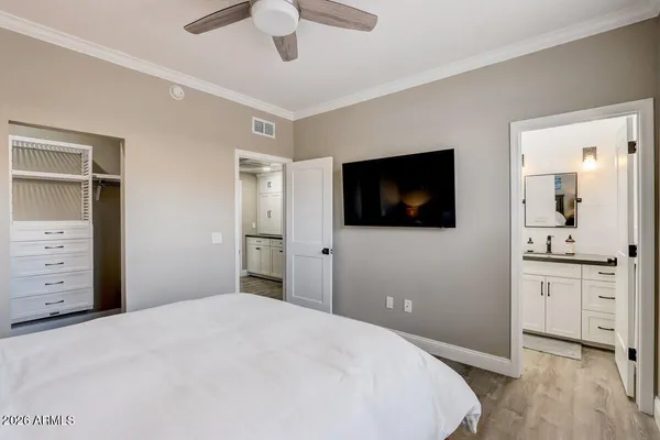 a bedroom with a bed and a flat screen tv