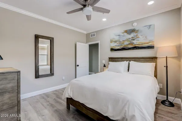 a bedroom with a bed and a chandelier
