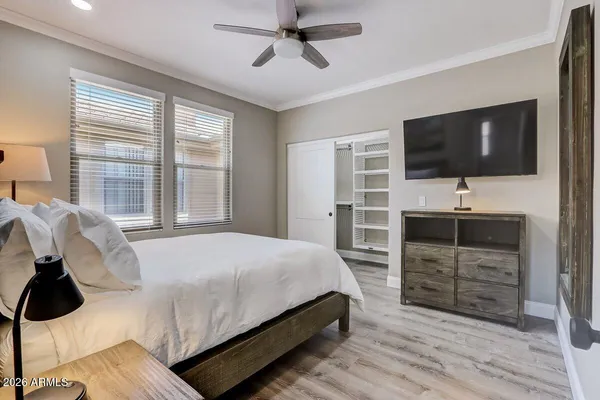 a bedroom with a bed and a flat screen tv