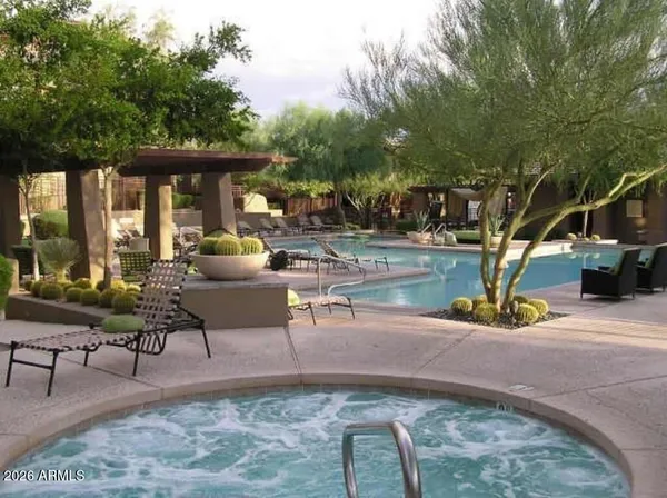 a building outdoor space with patio furniture and potted plants