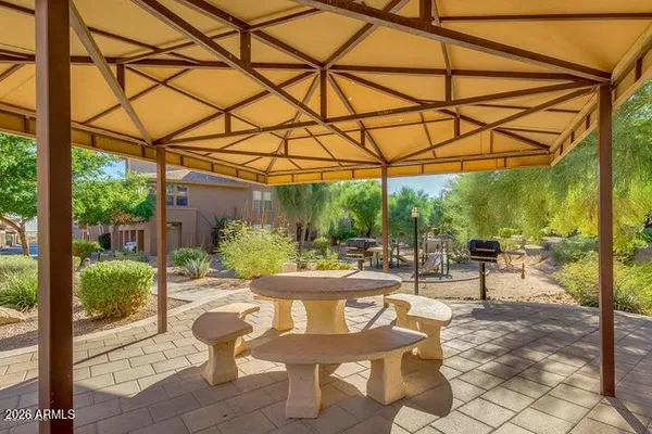 a view of a patio with table and chairs and potted plants