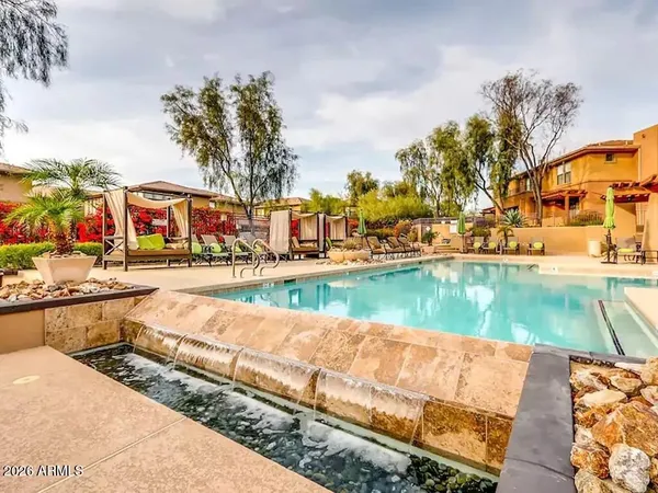 a view of swimming pool with outdoor seating and lake view