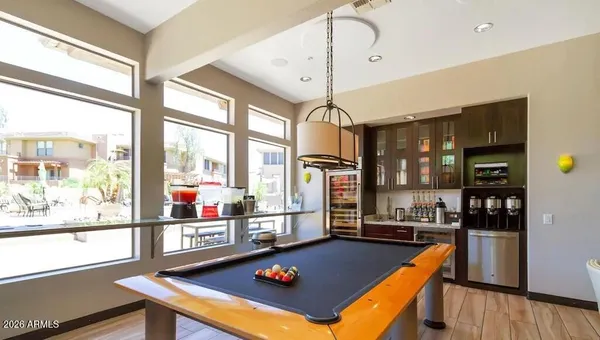 a room with pool table and window