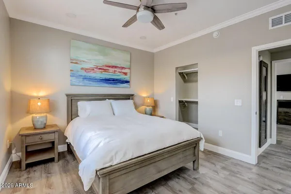 a bedroom with a bed and a chandelier