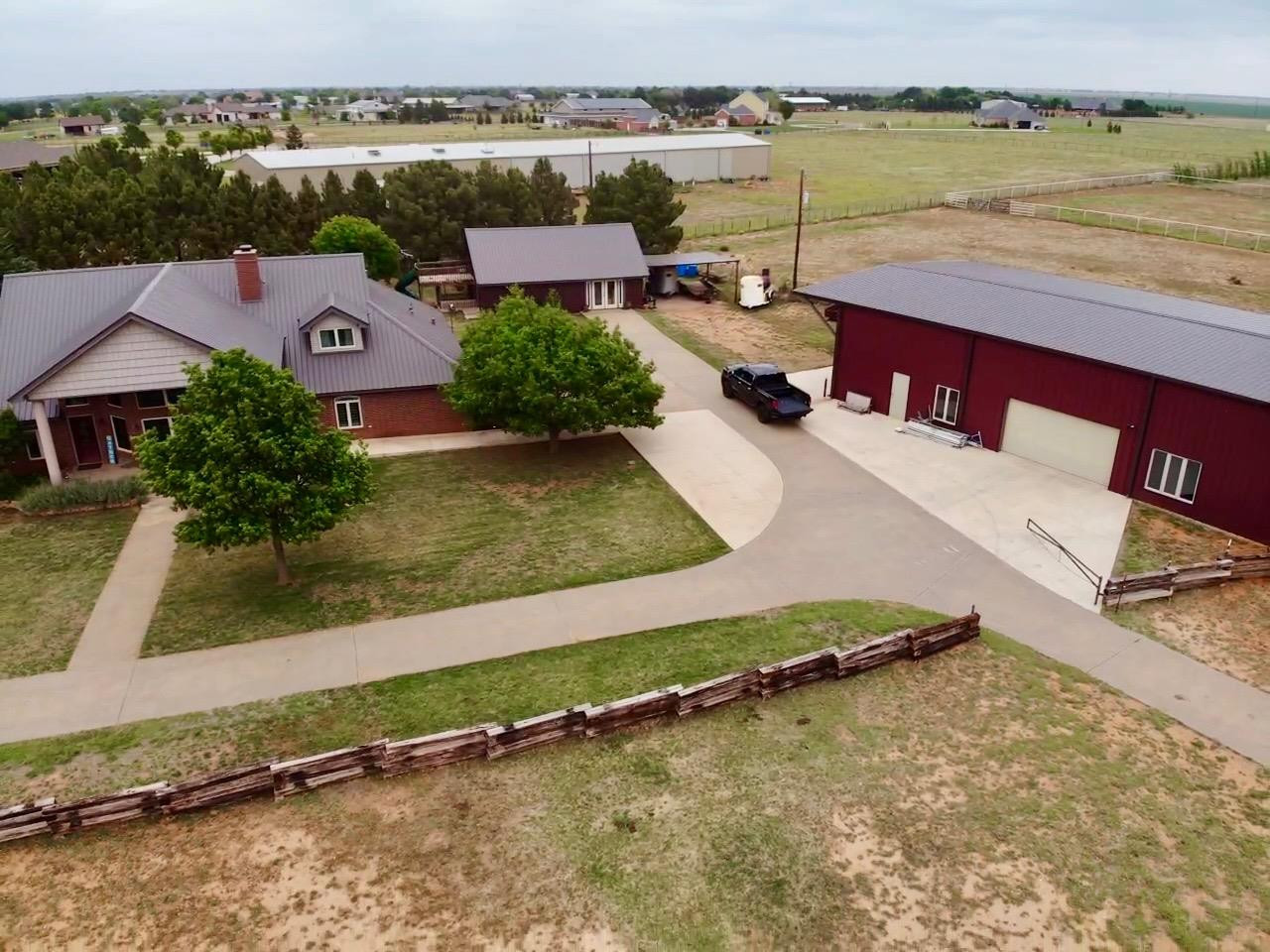 9002 Woodrow Road Wolfforth, TX 79382 - Photo 41 of 48 an aerial view of a house with a yard and lake view