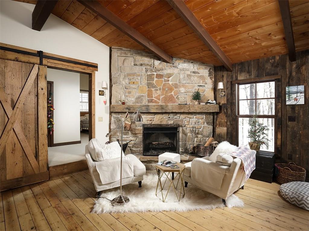 250 Imperial Road Hidden Valley, PA 15502 - Photo 3 of 25 Some old...some new...addition of master bedroom is beyond the barn door! Wood burning fireplace and view of the slopes!