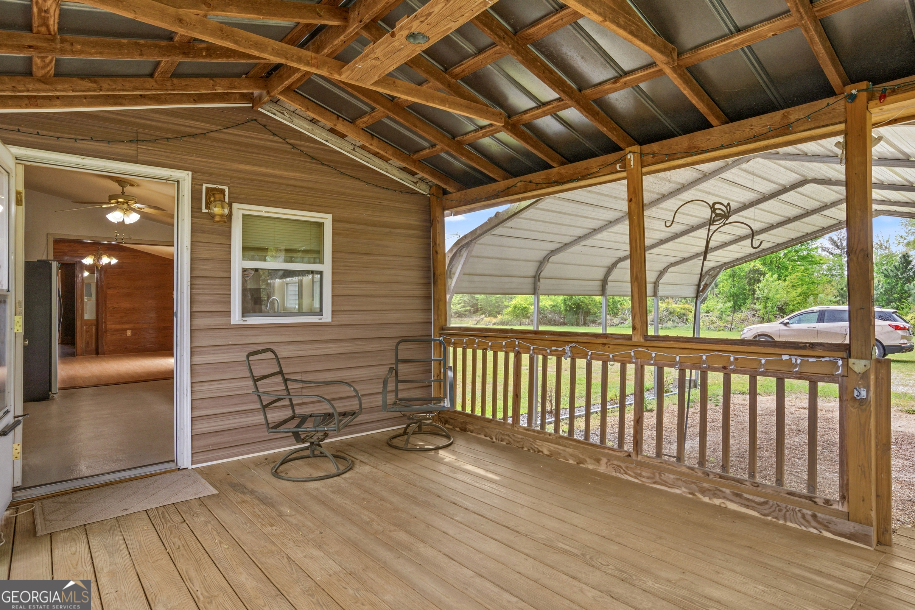 2010 Page Road Harrison, GA 31035 - Photo 57 of 59 a view of a porch with wooden floor and iron stairs