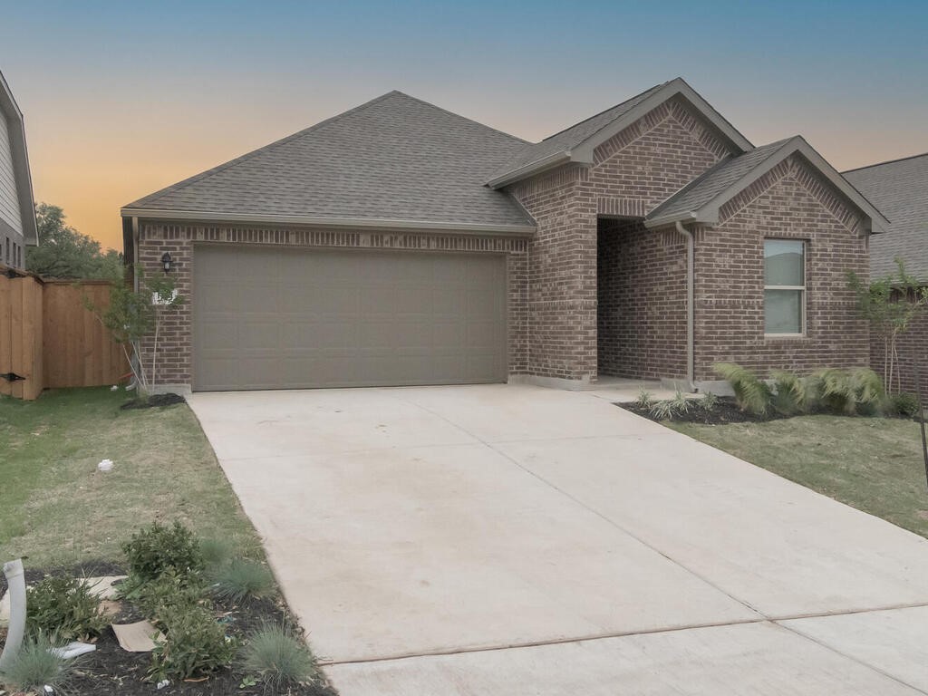 1104 Ridge Runner Drive Georgetown, TX 78628 - Photo 1 of 1 a front view of a house with a yard and garage