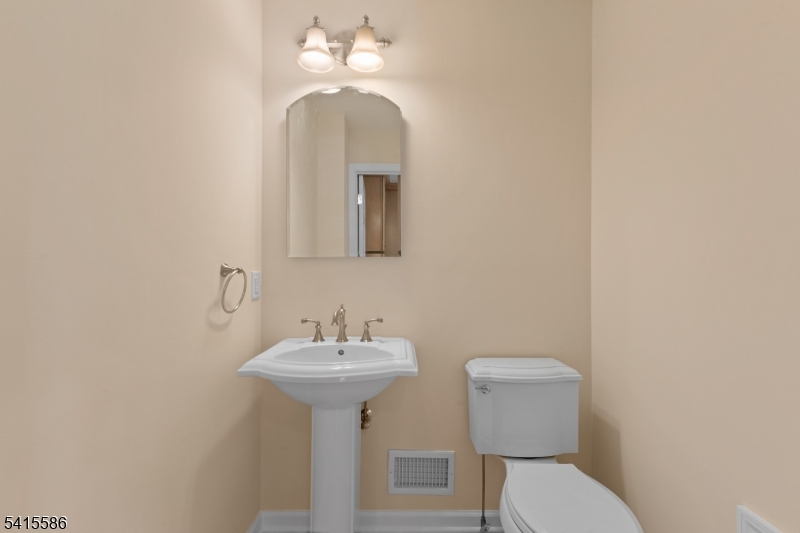 97 McCosh Road Montclair, NJ 07043 - Photo 14 of 25 a bathroom with a toilet sink and mirror