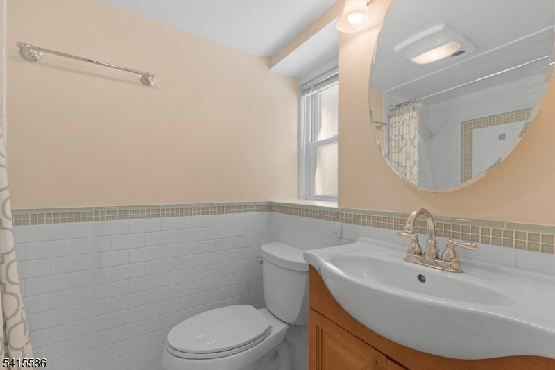 97 McCosh Road Montclair, NJ 07043 - Photo 22 of 25 a bathroom with a sink a toilet and mirror