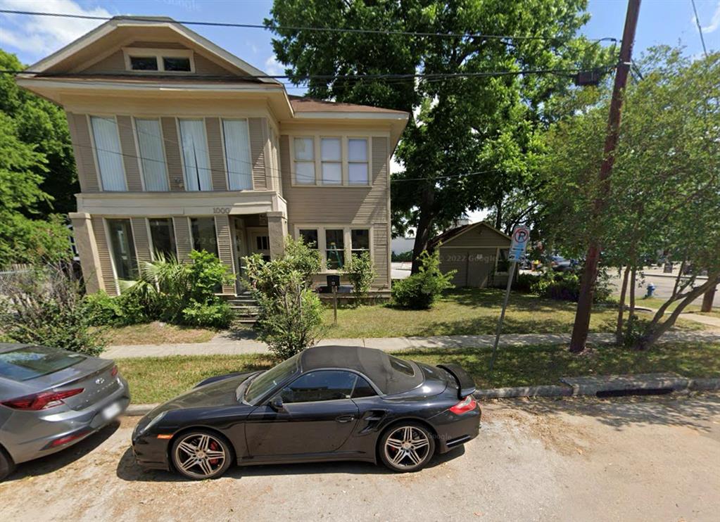 a view of a car parked in front of a house