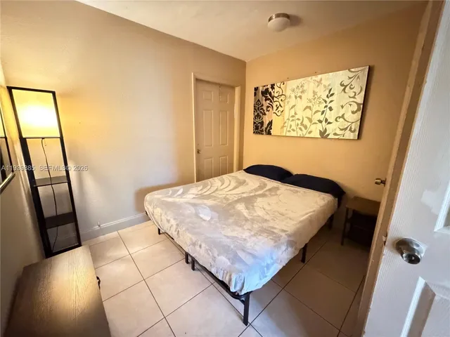 a bedroom with a bed and a mirror