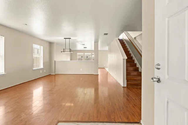 a view of a room with wooden floor and staircase
