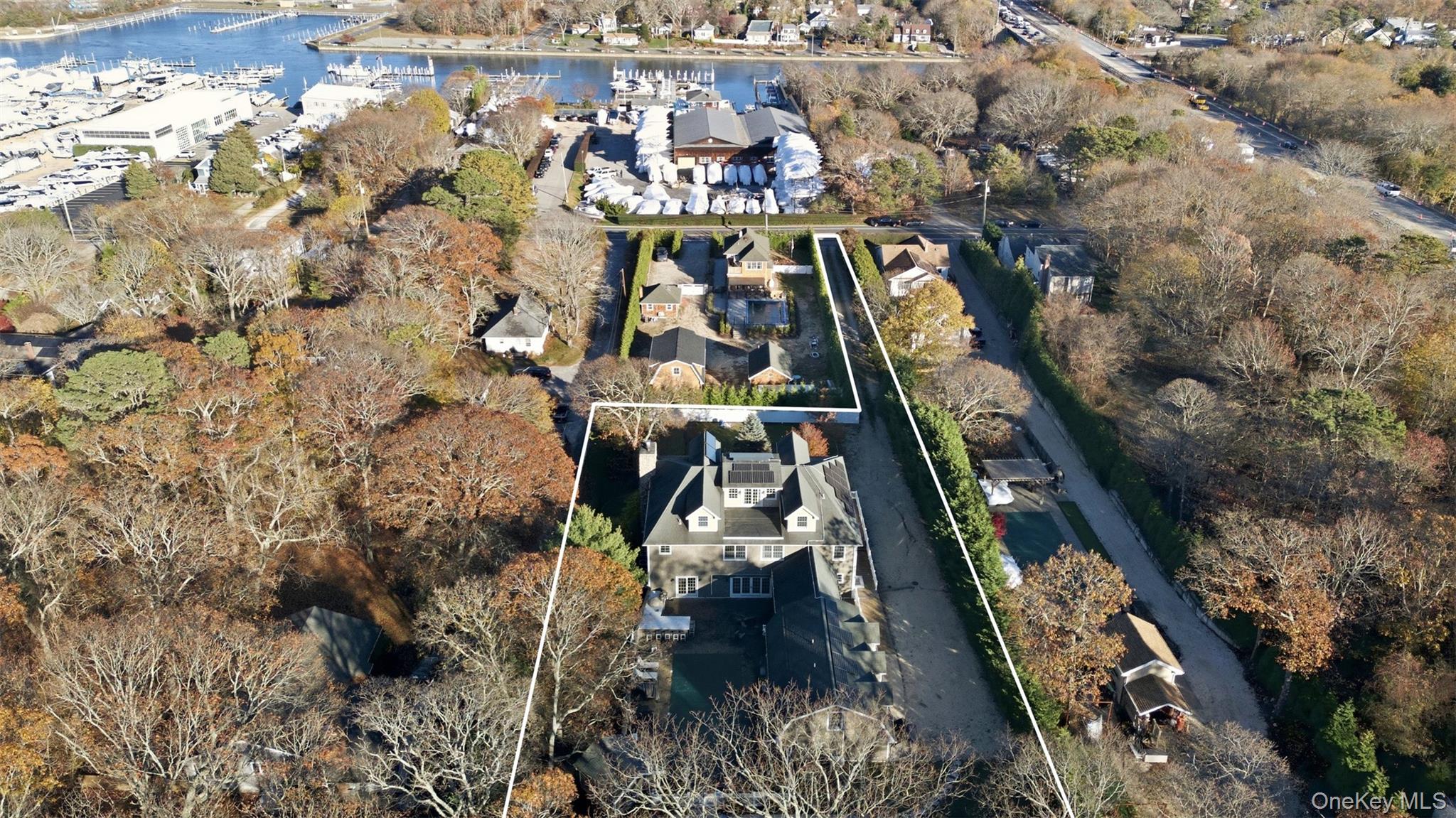 33 A Newtown Road Hampton Bays, NY 11946 - Photo 16 of 50 Aerial overview of property's location featuring a nearby body of water, property parcel outlined, and nearby suburban area