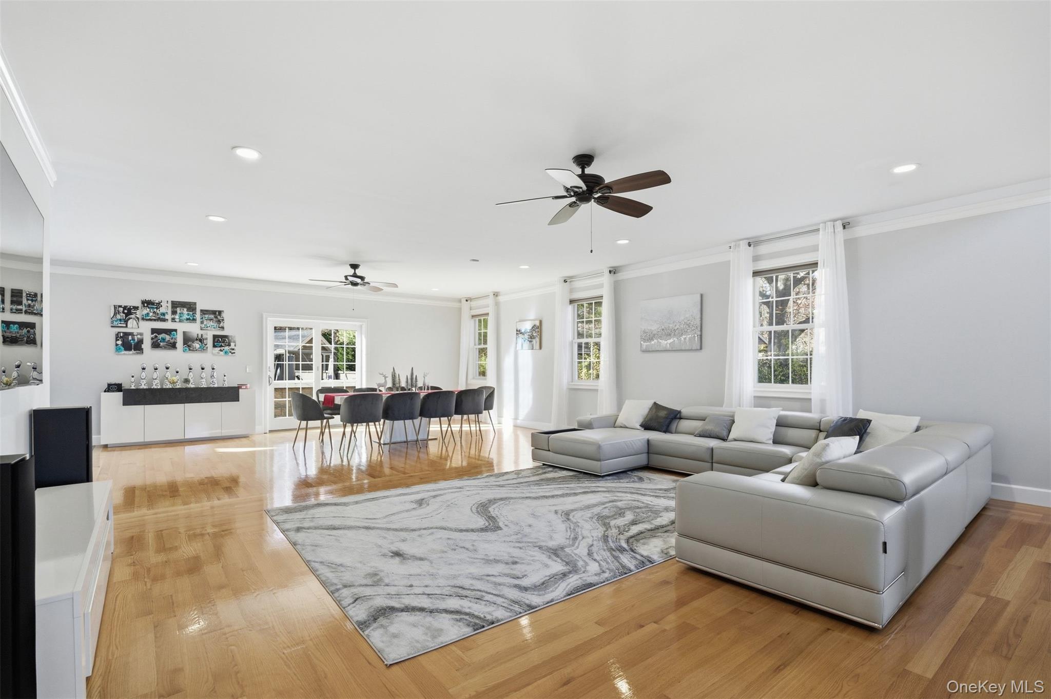 33 A Newtown Road Hampton Bays, NY 11946 - Photo 21 of 50 a living room with furniture and a flat screen tv