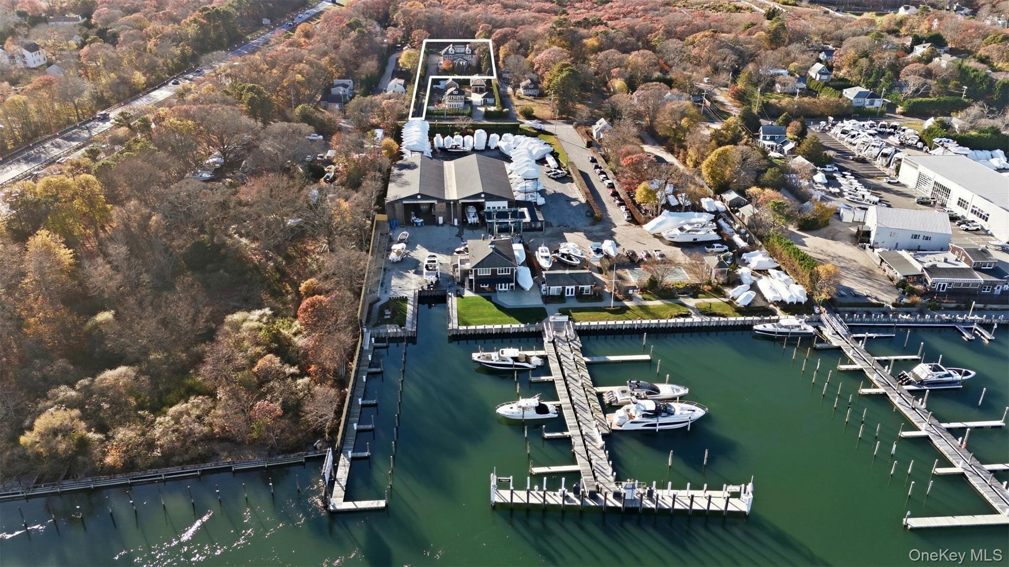 33 A Newtown Road Hampton Bays, NY 11946 - Photo 3 of 50 Aerial view of property and surrounding area featuring a nearby body of water and numerous boat docks