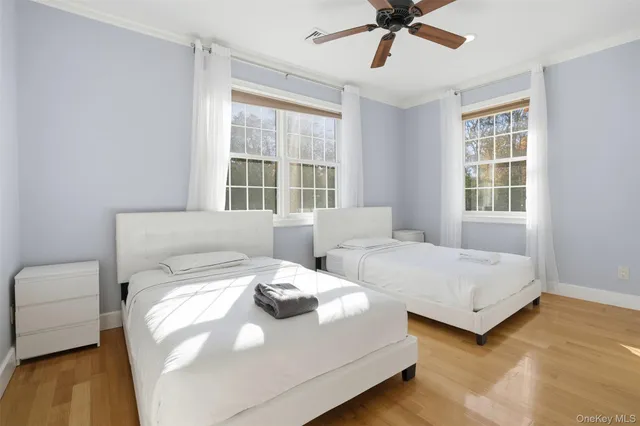 a bedroom with two beds and a chandelier