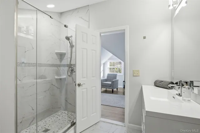 a large living room with stainless steel appliances granite countertop furniture and a flat screen tv