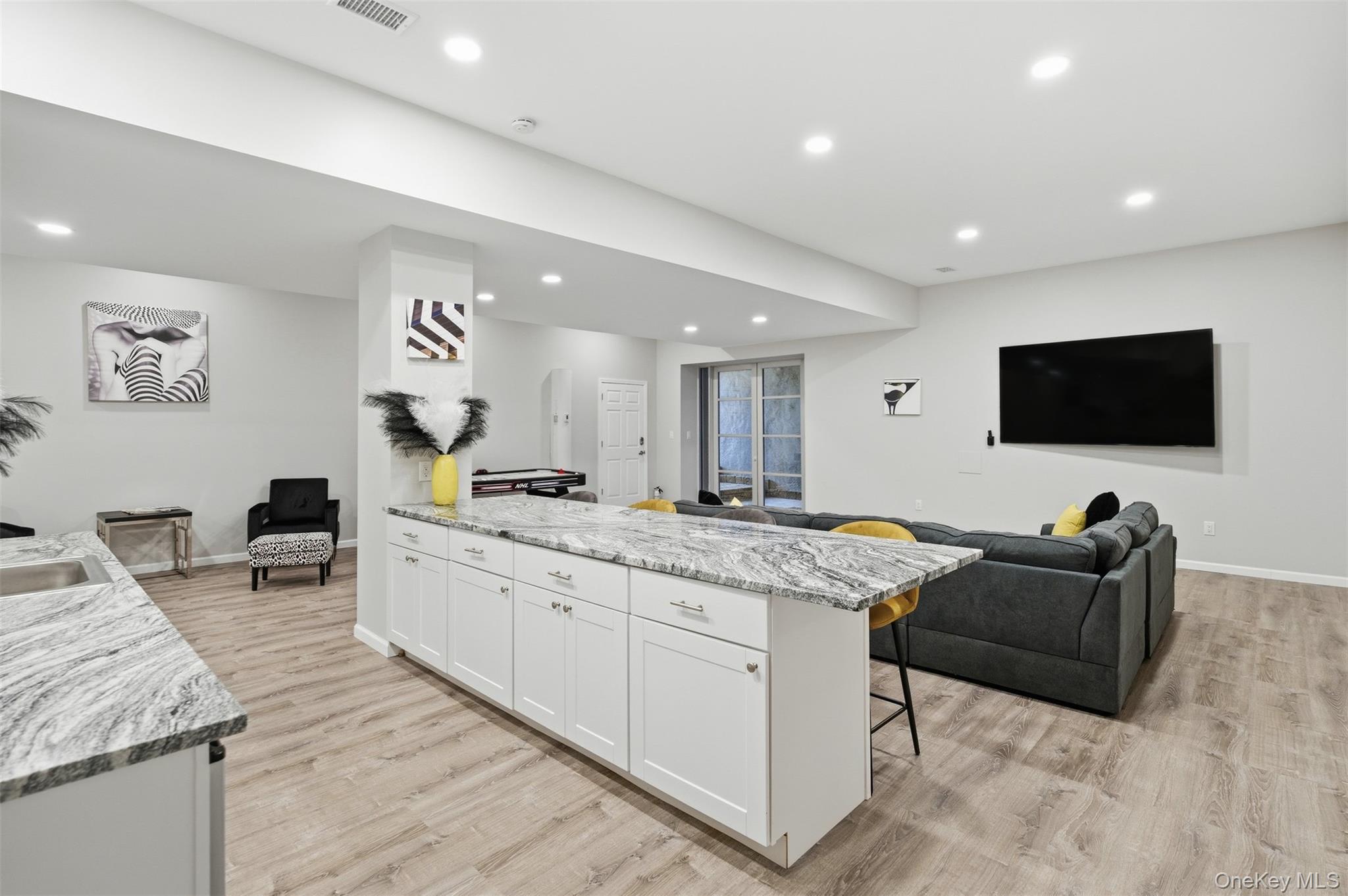 33 A Newtown Road Hampton Bays, NY 11946 - Photo 49 of 50 a large living room with stainless steel appliances granite countertop furniture and a flat screen tv