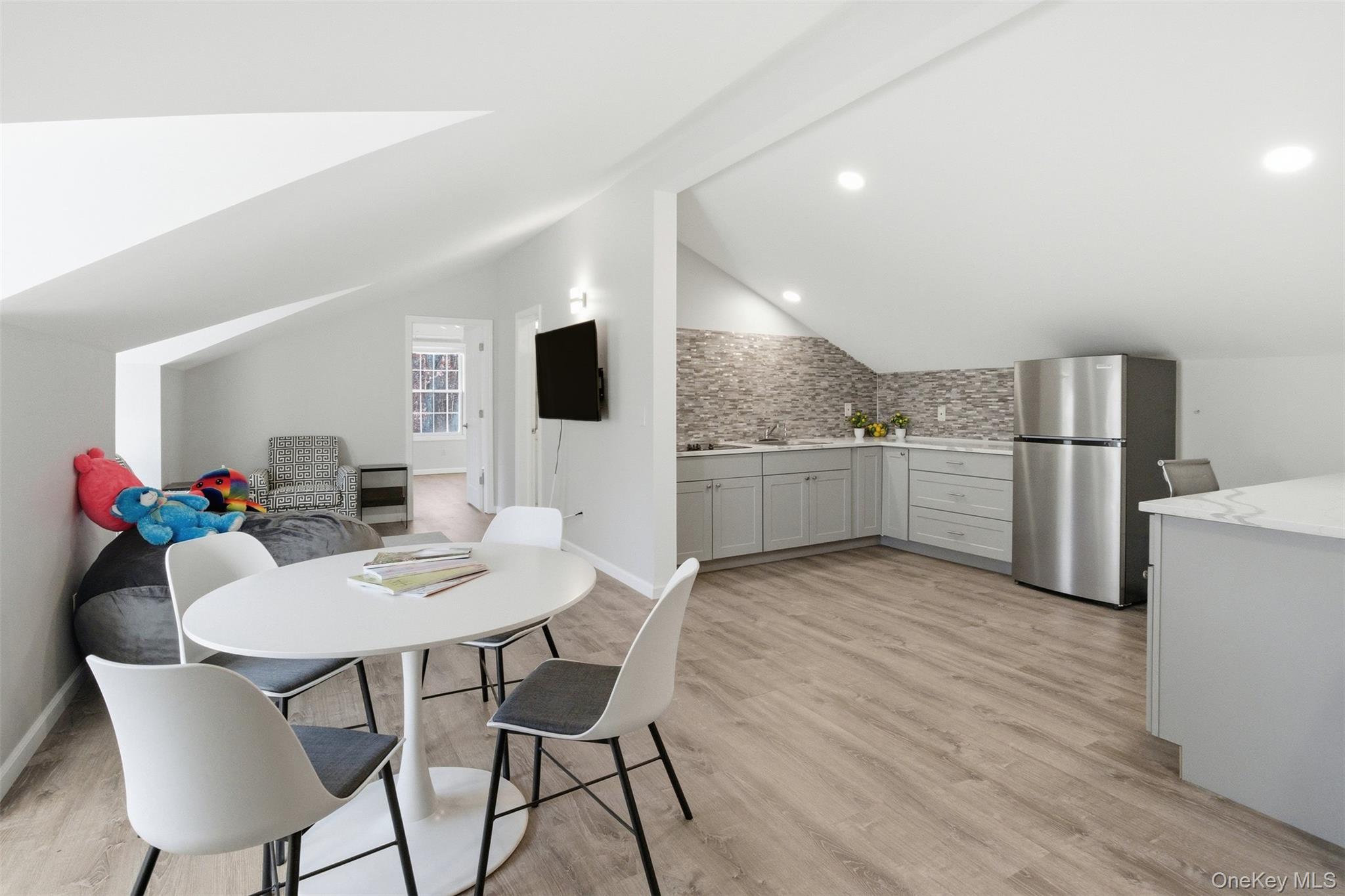 33 A Newtown Road Hampton Bays, NY 11946 - Photo 47 of 50 a view of a dining room with furniture and wooden floor