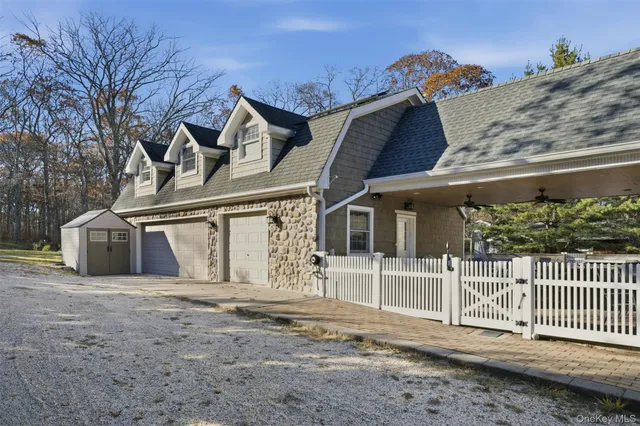 a view of a house with a wooden fence