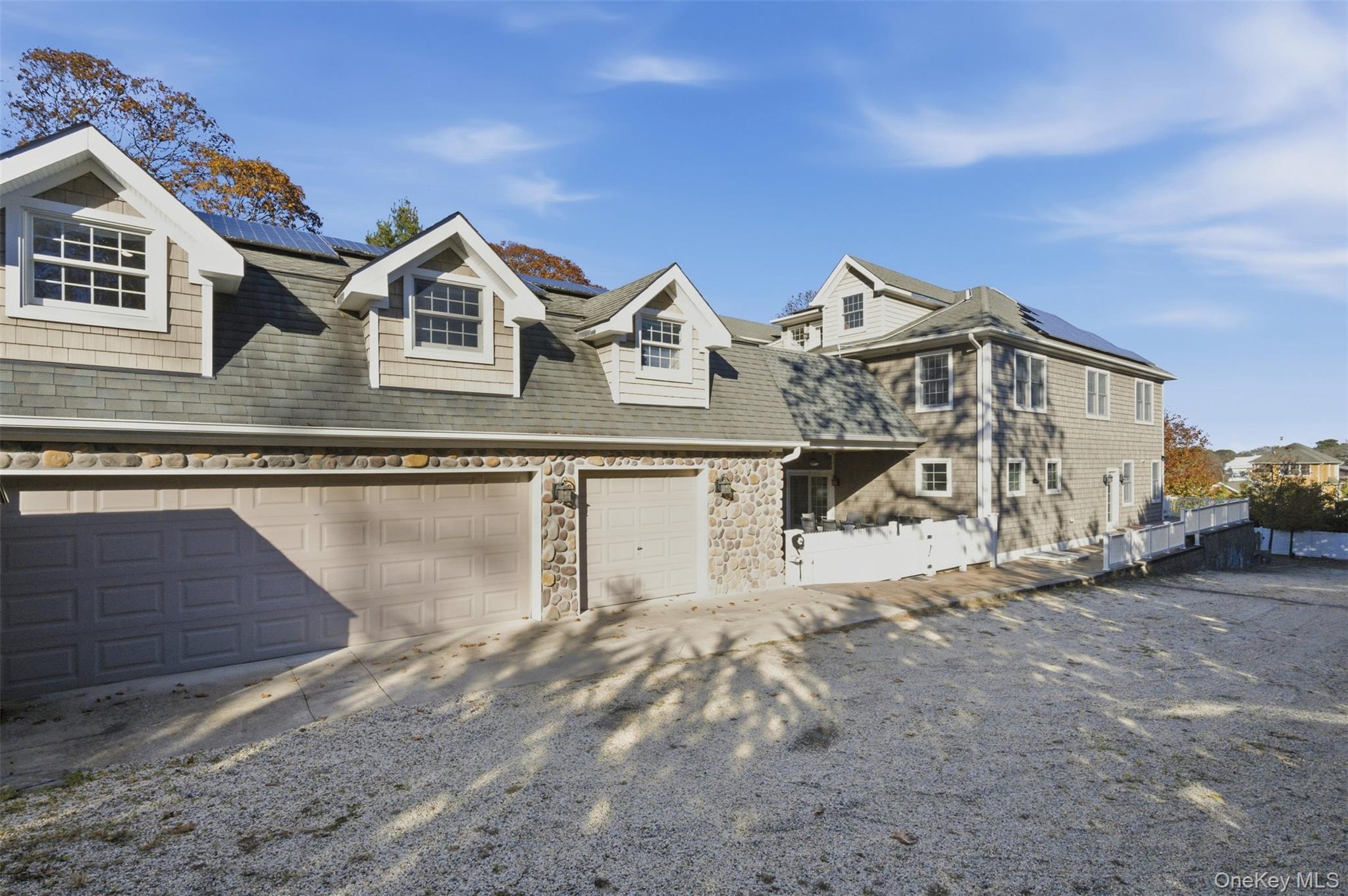 33 A Newtown Road Hampton Bays, NY 11946 - Photo 6 of 50 a view of a house with a wooden fence