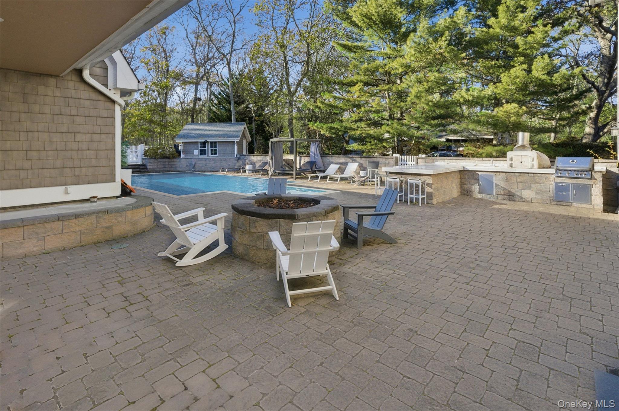33 A Newtown Road Hampton Bays, NY 11946 - Photo 8 of 50 View of swimming pool with exterior kitchen, a patio area, a fire pit, and an outdoor structure
