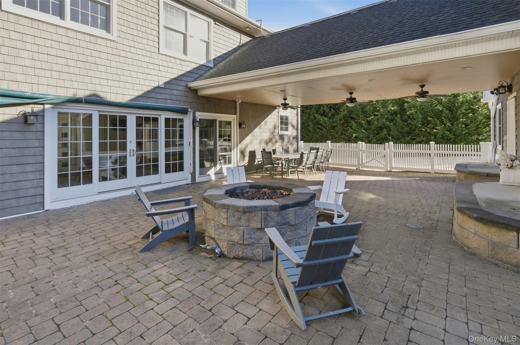 33 A Newtown Road Hampton Bays, NY 11946 - Photo 10 of 50 View of patio / terrace featuring a fire pit, outdoor dining area, french doors, and ceiling fan