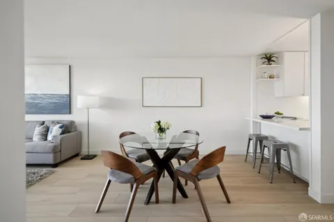 a bedroom with a bed and painting on the wall