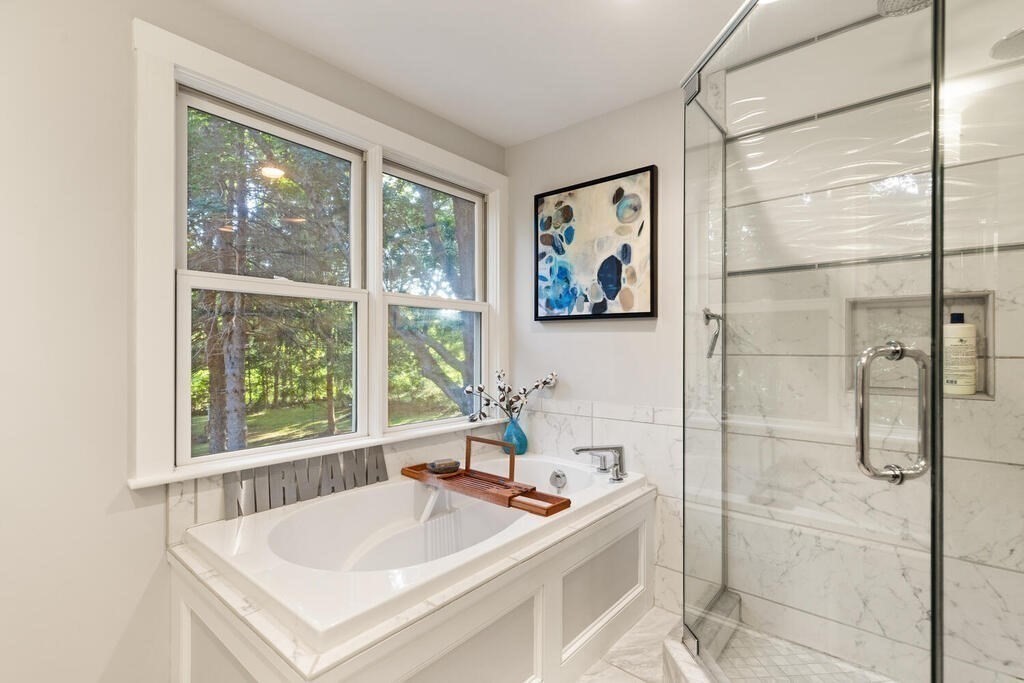 15 Labor In Vain Road Ipswich, MA 01938 - Photo 26 of 37 a bathroom with a tub a sink and a large window