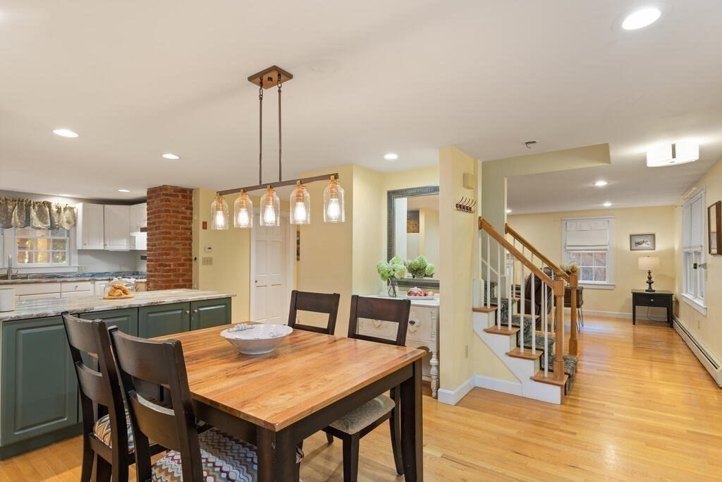15 Labor In Vain Road Ipswich, MA 01938 - Photo 3 of 37 a dining hall with stainless steel appliances a table and chairs with wooden floor