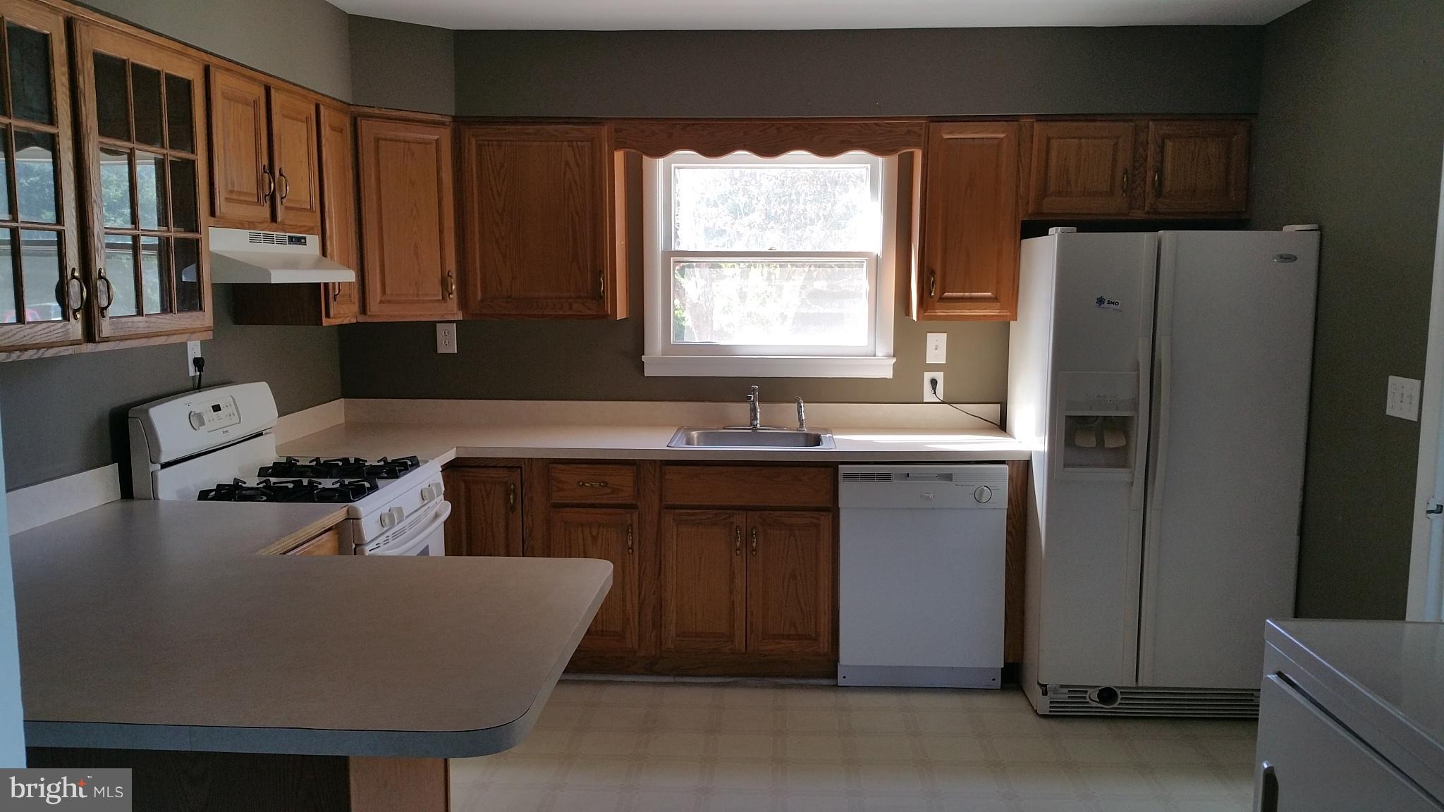 310 German Chapel Road Prince Frederick, MD 20678 - Photo 3 of 9 a kitchen with stainless steel appliances granite countertop a sink stove and refrigerator