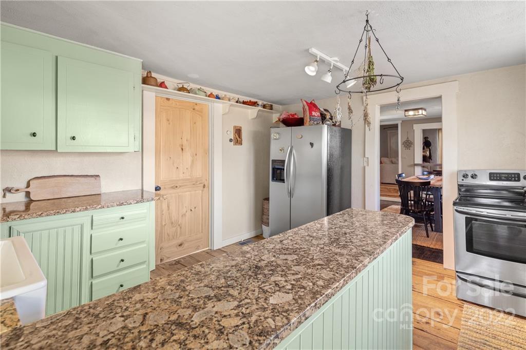 20 Indian Camp Branch Road Weaverville, NC 28787 - Photo 12 of 18 a kitchen with a refrigerator and countertop