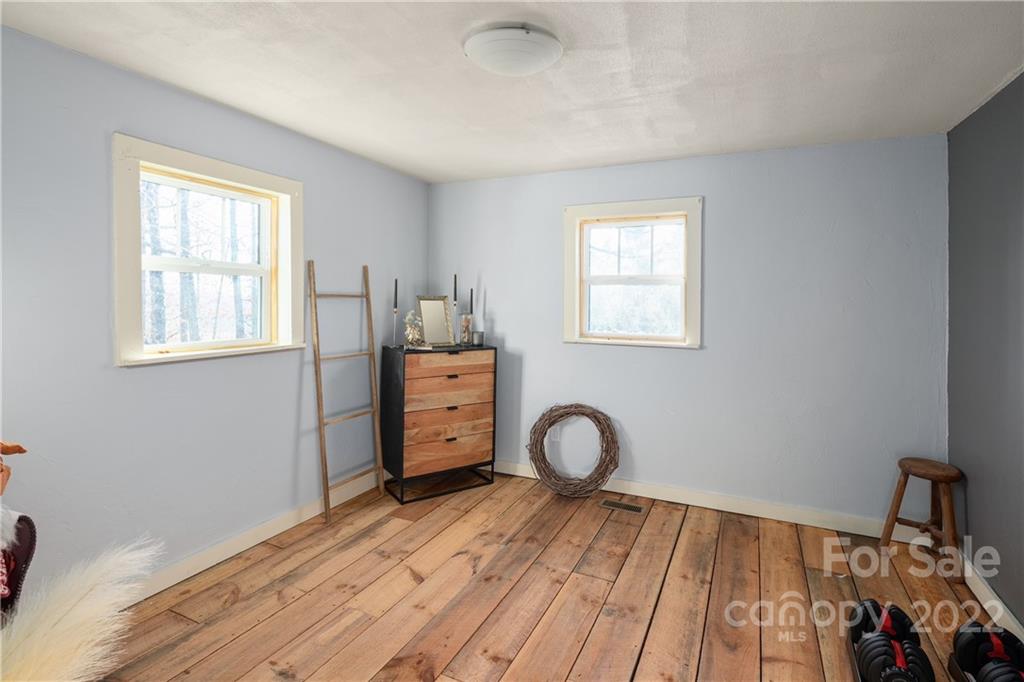 20 Indian Camp Branch Road Weaverville, NC 28787 - Photo 14 of 18 a view of a livingroom with wooden floor and a window