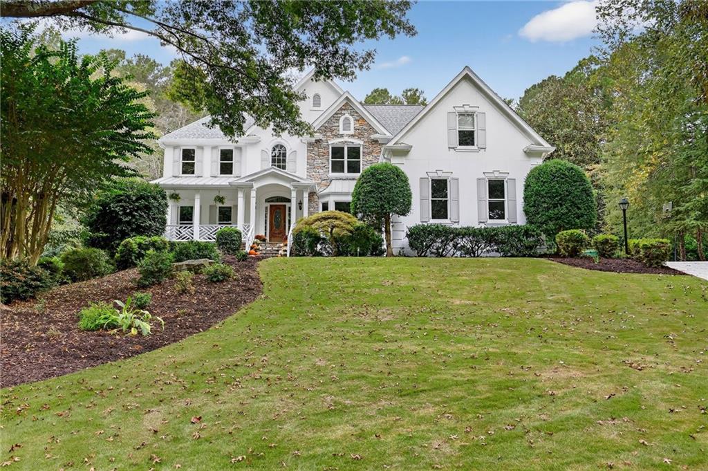 15420 Treyburn Manor View Alpharetta, GA 30004 - Photo 1 of 1 a front view of a house with a yard