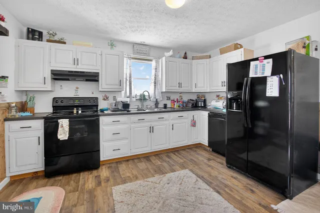 a kitchen with a sink a stove and refrigerator