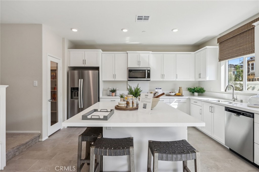 83239 Pintail Lane Indio, CA 92201 - Photo 15 of 45 a kitchen with white cabinets a sink stove and refrigerator