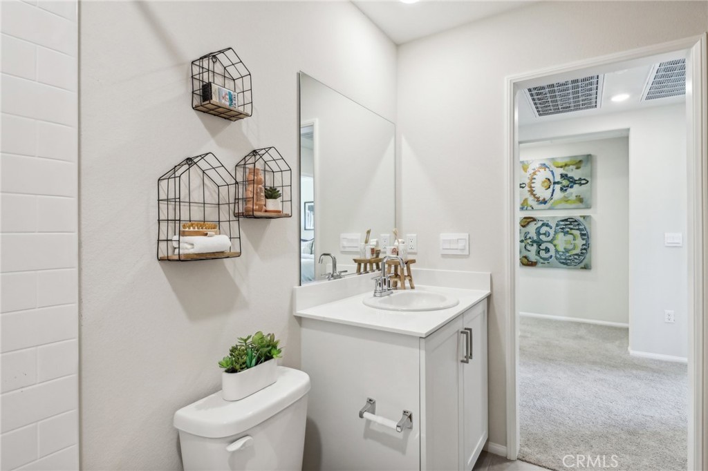 83239 Pintail Lane Indio, CA 92201 - Photo 30 of 45 a bathroom with a toilet a sink and mirror