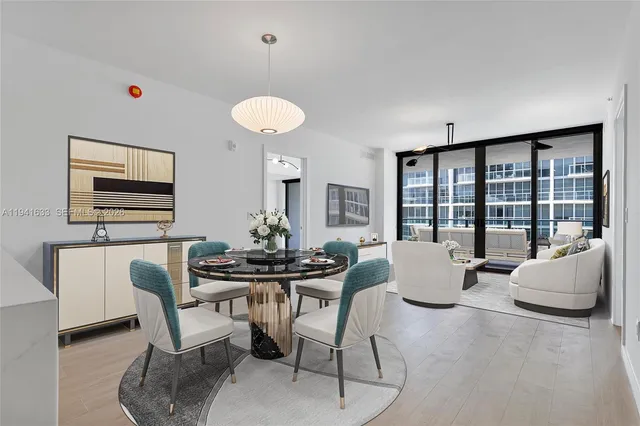 a living room with furniture and floor to ceiling window