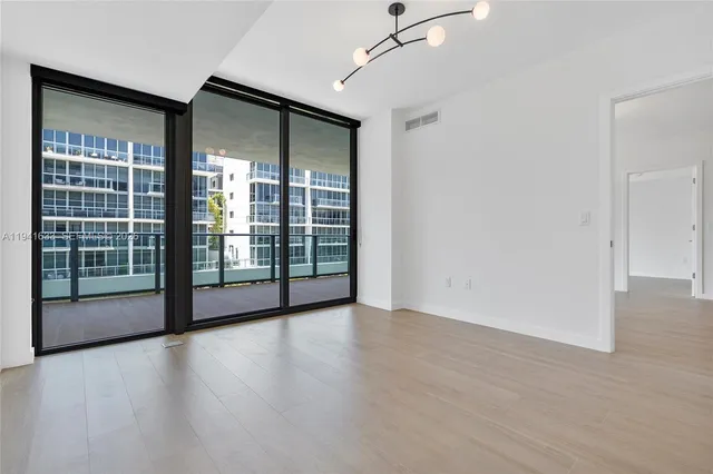 a view of a big room with windows and balcony
