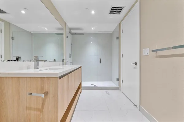 a bathroom with a double vanity sink and a mirror