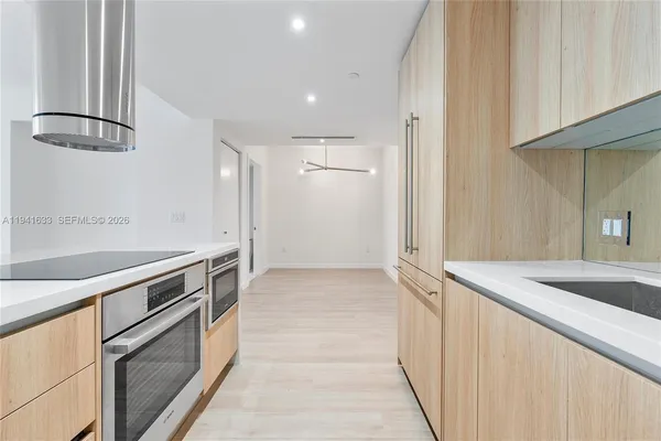 a kitchen with granite countertop a sink and stainless steel appliances